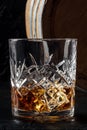 Whiskey in a glass with a barrel. Bourbon whisky and a cask on a dark background Royalty Free Stock Photo