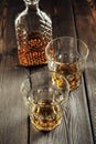 Whiskey glass and bottle on the old wooden table Royalty Free Stock Photo