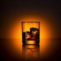 Whiskey glass bourbon with ice cubes rocks and orange sunset dawn summer Royalty Free Stock Photo