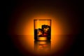 Whiskey glass bourbon with ice cubes rocks and orange sunset dawn summer Royalty Free Stock Photo