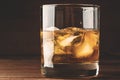 Whiskey in glass with cubes of ice on dark background close up Royalty Free Stock Photo