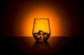 Whiskey glass drink with ice cubes and orange sunset summer Royalty Free Stock Photo