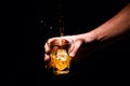 Whiskey glass in a hand of a man Royalty Free Stock Photo