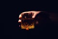 Whiskey glass in a hand of a man Royalty Free Stock Photo