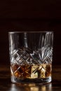 Whiskey in a glass with ice. Bourbon whisky on rocks on a dark background Royalty Free Stock Photo