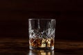 Whiskey in a glass with ice. Bourbon whisky on rocks on a dark background Royalty Free Stock Photo