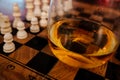 Whiskey glass on a chess board Royalty Free Stock Photo