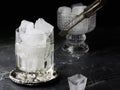 Whiskey glass with ice cubes. A transparent glass for whiskey or other strong drinks filled with ice rocks. Empty crystal glass Royalty Free Stock Photo