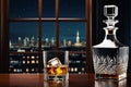 Whiskey glass jag decanter on wooden counter with view to night city Royalty Free Stock Photo