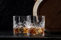 Whiskey in glasses with a barrel. Bourbon whisky and a cask on a dark background Royalty Free Stock Photo