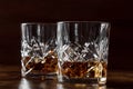 Whiskey in glasses with ice. Bourbon whisky on rocks on a dark background Royalty Free Stock Photo