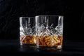 Whiskey in glasses with ice. Bourbon whisky on rocks on a dark background Royalty Free Stock Photo