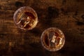 Whiskey in glasses with ice. Bourbon whisky on rocks on a dark background Royalty Free Stock Photo