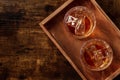 Whiskey in glasses with ice. Bourbon whisky on rocks on a dark background Royalty Free Stock Photo