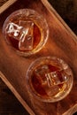 Whiskey in glasses with ice. Bourbon whisky on rocks on a dark background Royalty Free Stock Photo