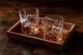 Whiskey in glasses with ice. Bourbon whisky on rocks on a dark rustic background Royalty Free Stock Photo