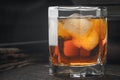 Whiskey with ice and blurred newspaper on the wooden table Royalty Free Stock Photo