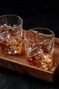 Whiskey with ice. Bourbon whisky on rocks on a dark wooden table Royalty Free Stock Photo