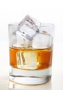 Whiskey with ice cubes in glass on white bg Royalty Free Stock Photo