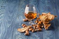 Whiskey and Oak acorns on wooden desk Royalty Free Stock Photo