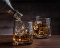 Whiskey pours from a bottle into a glass Royalty Free Stock Photo