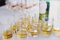 Whiskey row on table party at wedding reception. Whisky in glasses at alcohol bar. Christmas and New Year feast. Celebrations and Royalty Free Stock Photo