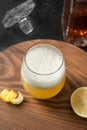 Whiskey sour cocktail - bourbon with lemon juice, sugar syrup or honey and egg white mixed in glass. Vertical orientation Royalty Free Stock Photo