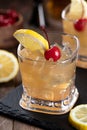 Whiskey sour cocktail with cherry and lemon Royalty Free Stock Photo