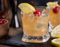 Whiskey sour cocktail with cherry and lemon Royalty Free Stock Photo