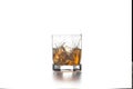 Whiskey splash from the fallen ice cube into glass with beverage on light background Royalty Free Stock Photo