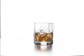 Whiskey splash from the fallen ice cube into glass with beverage on light background Royalty Free Stock Photo