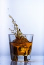 Whiskey splashes in a glass on a light background6