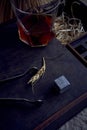 whiskey with tongs, stone cubes, wooden box and wheat on carpet