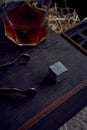 whiskey with tongs, stone cubes, wooden box and wheat on carpet