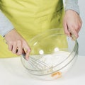 Whisking batter in kitchen Royalty Free Stock Photo