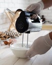 Whisking egg whites and granulated sugar on white wooden table Royalty Free Stock Photo