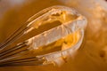 Whisking egg yolks, sugar and `mascarpone` cheese in a bowl to make the traditional, italian Mascarpone cream dessert