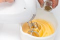 Whisking eggs and adding ingredients Royalty Free Stock Photo