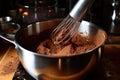 whisking hot chocolate mixture in a saucepan Royalty Free Stock Photo