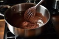 whisking hot chocolate mixture in a saucepan