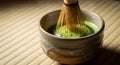 Whisking matcha in ceramic bowl on tatami with soft shadows creates micro-foam Royalty Free Stock Photo