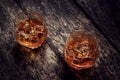 Whisky bourbon in two glasses on dark wooden table backgroudnd Royalty Free Stock Photo