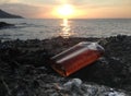 Whisky in flat Bottles on rock beach