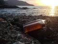 Whisky in flat Bottles on rock beach