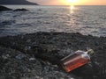 Whisky in flat Bottles on rock beach