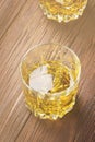 Whisky with ice in two glasses on a wooden background. Toned. Royalty Free Stock Photo