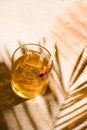 Whisky liqueur glass with ice cubes on the beach Royalty Free Stock Photo