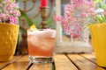 Whisky sour cocktail with foam, selective focus. Classic drink with whiskey, bourbon, lemon juice, on a wooden table.