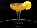 A whisky sour in a coupe glass with a lemon wagon wheel garnish. Royalty Free Stock Photo