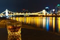 whisky on table, city waterfront with litup bridges beyond Royalty Free Stock Photo